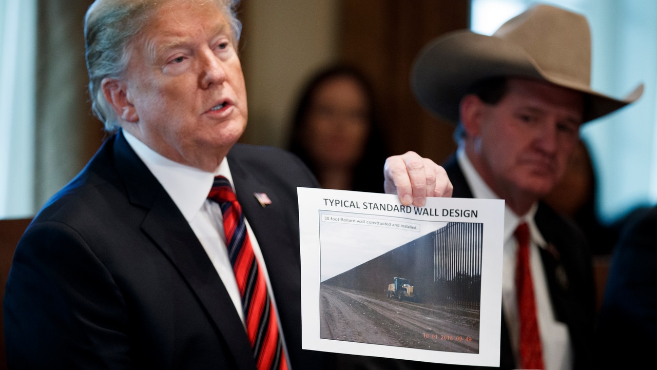 US President Donald Trump presents a 'typical standard wall design' as he participates in a roundtable discussion on border security on 11/1/19.