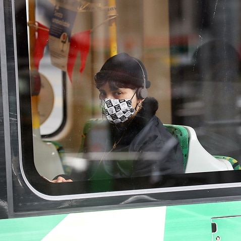 A tram passenger wearing a mask in Melbourne.