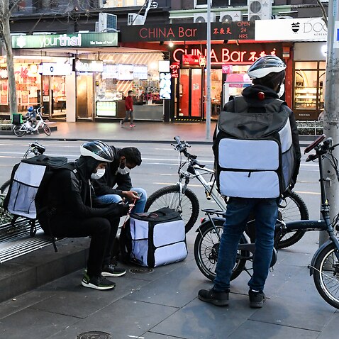 Delivery riders are seen in the Melbourne CBD.