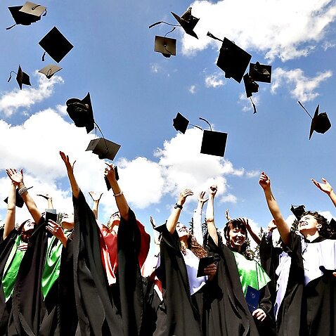 Image of graduates throwing hats