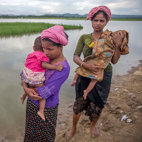 Rohingya Muslim women and their children cross over from Myanmar to Bangladesh. Many are at risk from colossal impacts of floods, cyclones and other environmental disasters linked to climate change.
