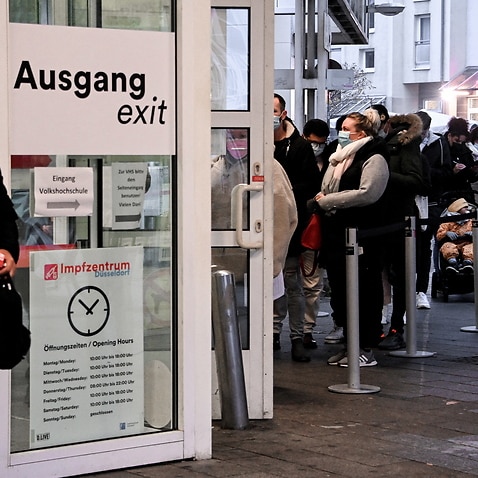 People queue for Covid-19 coronavirus vaccination at the main station vaccination centre in Duesseldorf, Germany