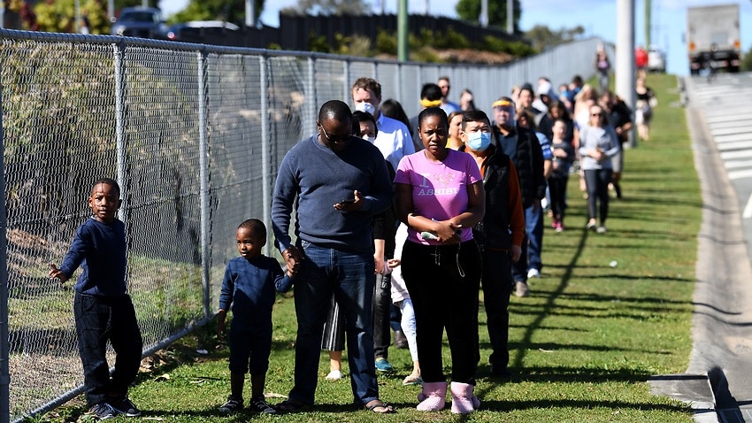 People line up to get COVID-19 tested at the Parklands Christian College in Logan, south of Brisbane, Wednesday, July 29, 2020. The school has been temporarily closed after an employee tested positive for COVID-19. (AAP Image/Dan Peled) NO ARCHIVING