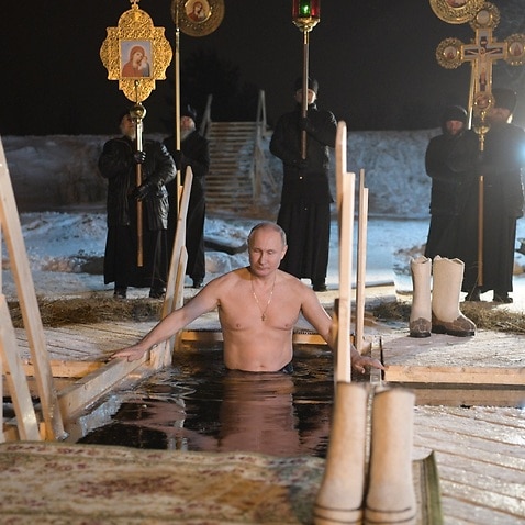 Russian President Vladimir Putin takes a dip in the ice cold water of the lake Seliger during the celebrations of the Orthodox Epiphany holiday