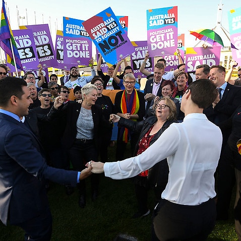 Same-sex marriage campaigners and volunteers cheer as they call on politicians to pass marriage equality legislation during an equality rally outside Parliament House in Canberra, Thursday, December 7, 2017. (AAP Image/Lukas Coch) NO ARCHIVING