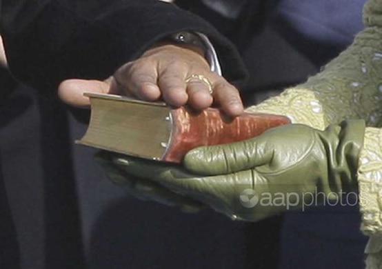 President Barack Obama rests his hand on President Lincoln's Inaugural Bible as his wife Michelle Obama holds it as he takes the oath of office at the U.S. Capitol in Washington, Tuesday, Jan. 20, 2009. 