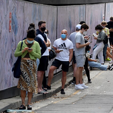 Members of the public queue for Covid19 PCR tests at a clinic in Redfern in Sydney, Friday, December 24, 2021. Indoor mask wearing, compulsory QR code check-ins and other restrictions lifted in NSW on December 15 will be reintroduced amid a record spike i