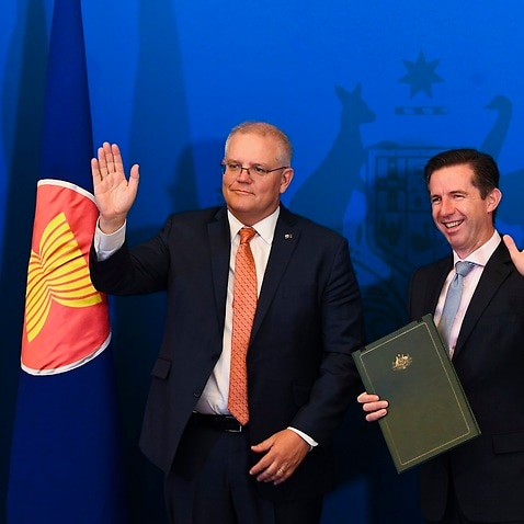 Australian Trade Minister Simon Birmingham (right) and Australian Prime Minister Scott Morrison react after signing the Regional Comprehensive Economic Partnership (RCEP).