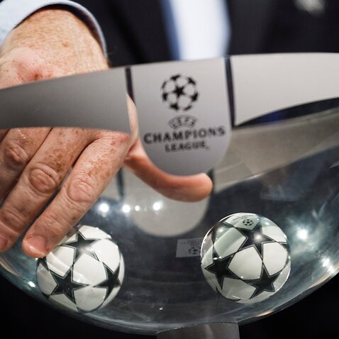A UEFA official picks up a ball during the draw of the first two qualifying rounds of the UEFA Champions League 2015/16.