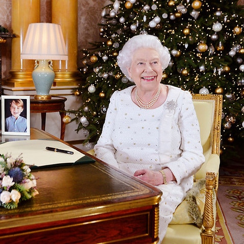 Britain's Queen Elizabeth sits at a desk in the 1844 Room at Buckingham Palace