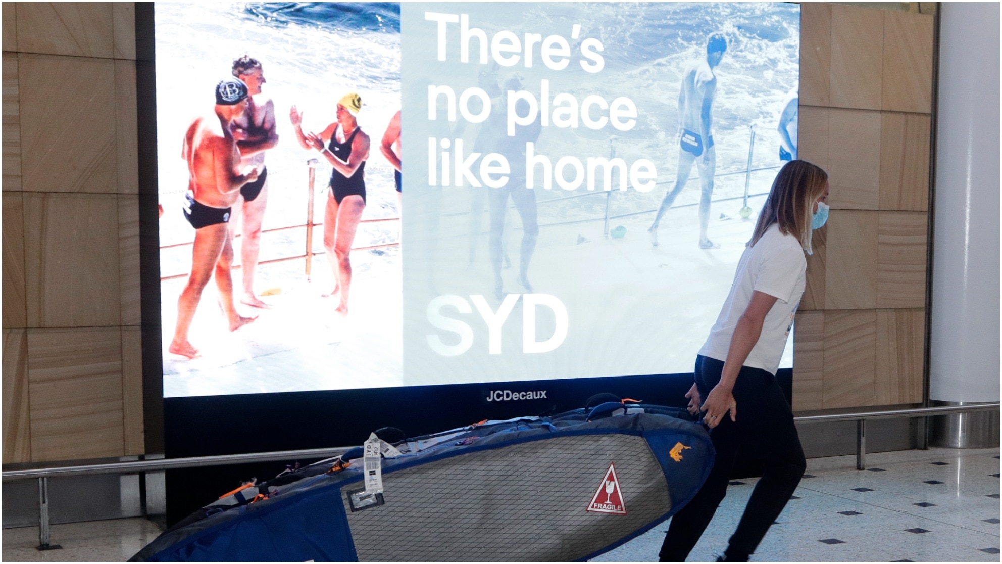 A woman arrives after a flight from Los Angeles at Sydney Airport as Australia open its borders for the first time in 19 months.