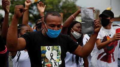 Demonstrators participate in a protest to demand justice after the massacre of five minors in Cali, Colombia, 19 August 2020.