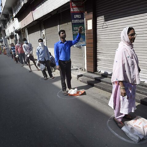 People shop for essentials during India's three-week lockdown