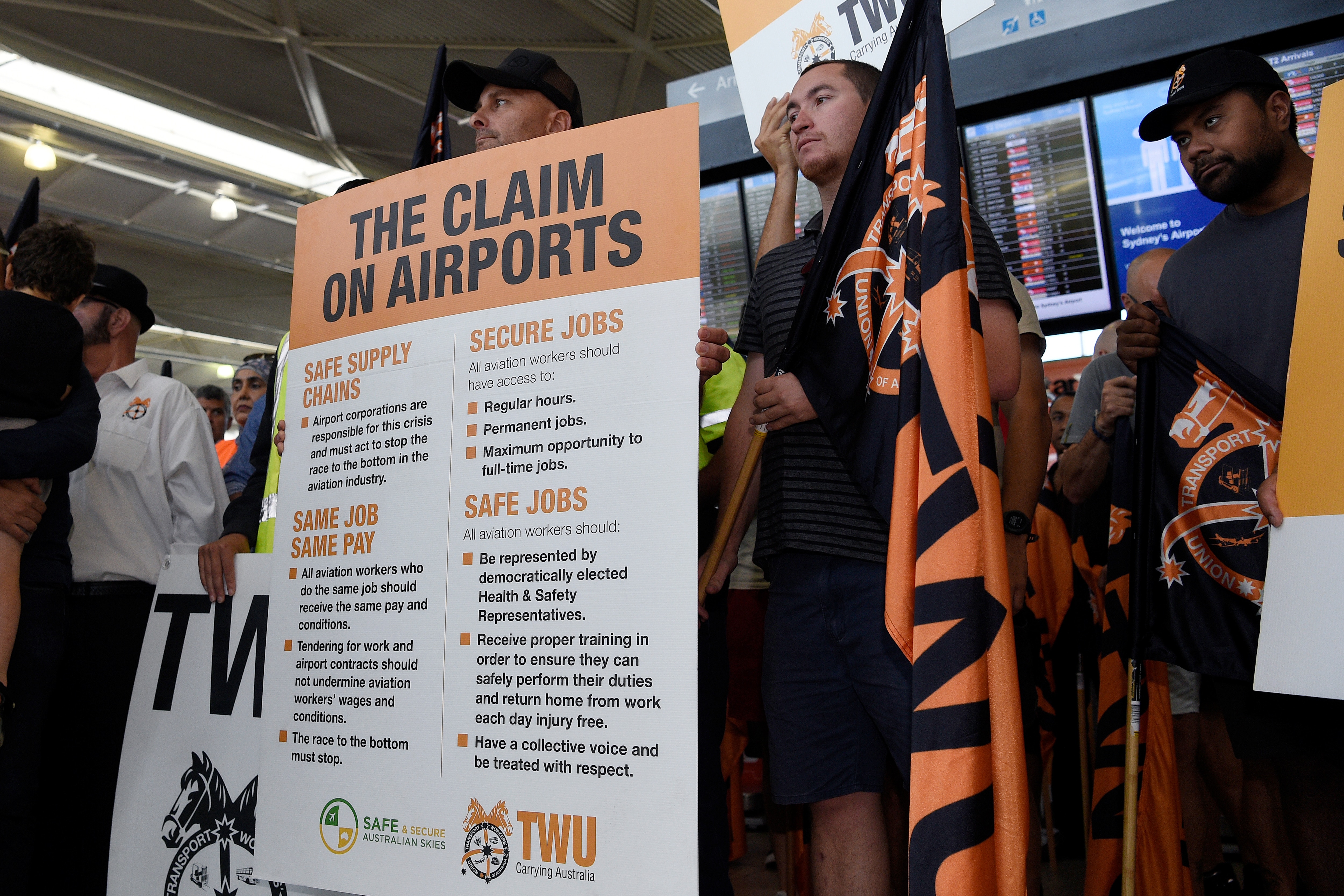 Jetstar workers held placards as they went on strike at Sydney Airport's Domestic Terminal.