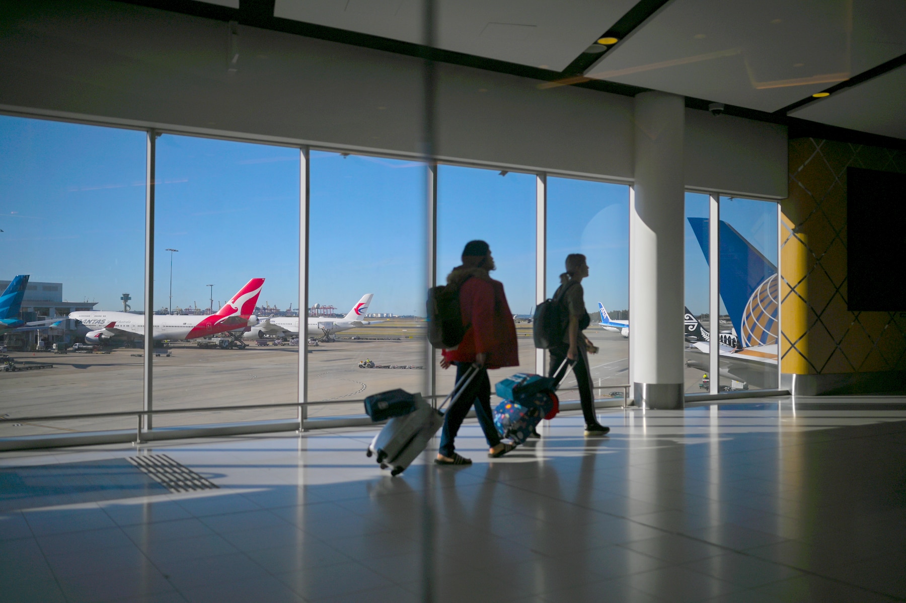 Passengers walk to their flights at Sydney International Airport in Sydney, Wednesday, August 21, 2019.