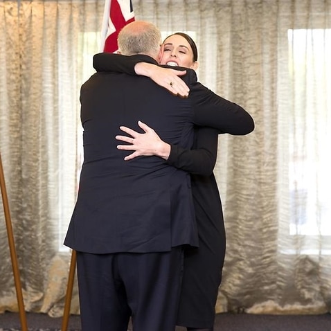 Australian PM Scott Morrison and New Zealand PM Jacinda Ardern hug a
