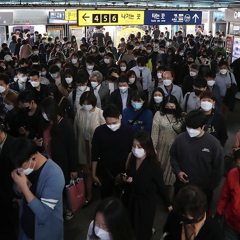 Commuters change trains in the morning rush hour at a subway station in Seoul, South Korea on Monday.