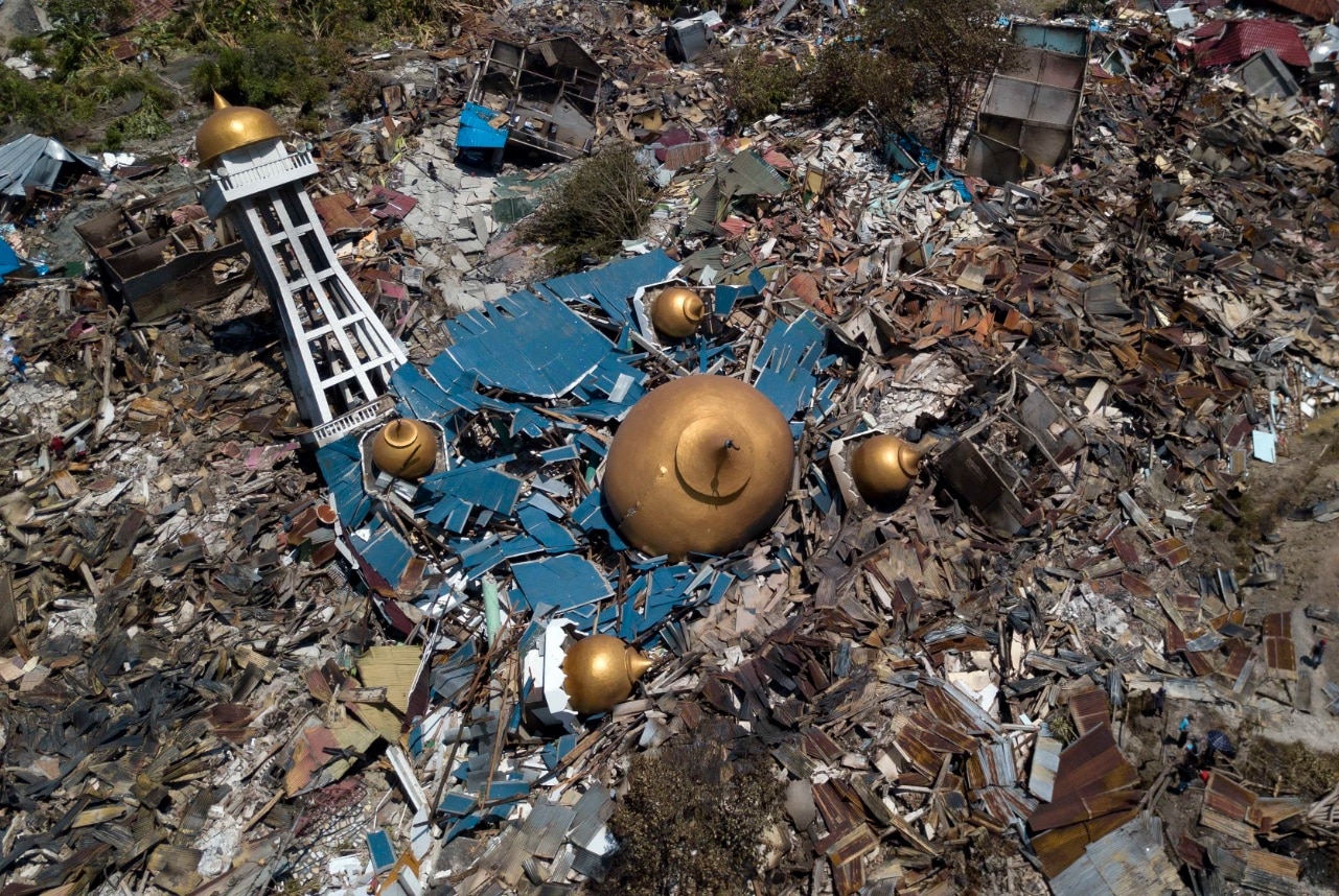 An aerial view taken with a drone camera of an earthquake devastated mosque and surrounding area in Palu, Central Sulawesi