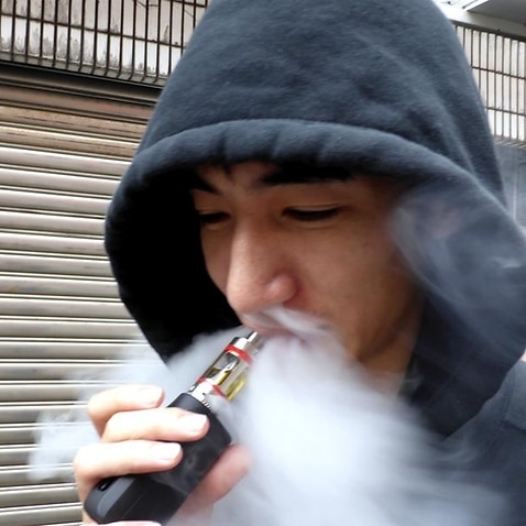 A man smokes an electronic cigarette.