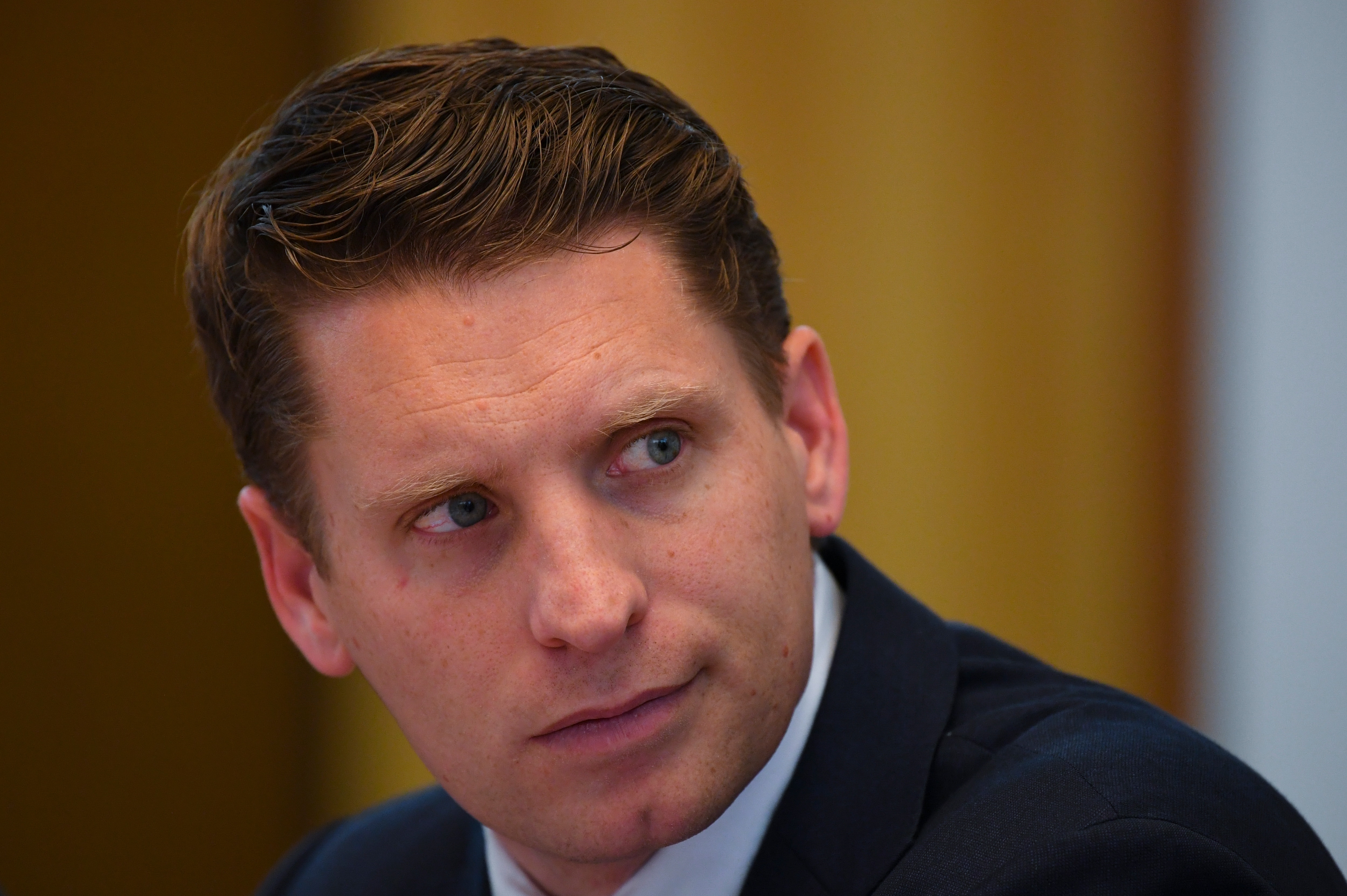 Committee chair Andrew Hastie reacts during a hearing of the Parliamentary Joint Committee on Intelligence and Security at Parliament House in Canberra.