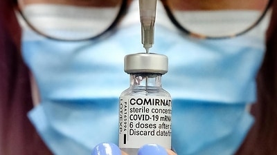 A file image of a health worker preparing a vaccine