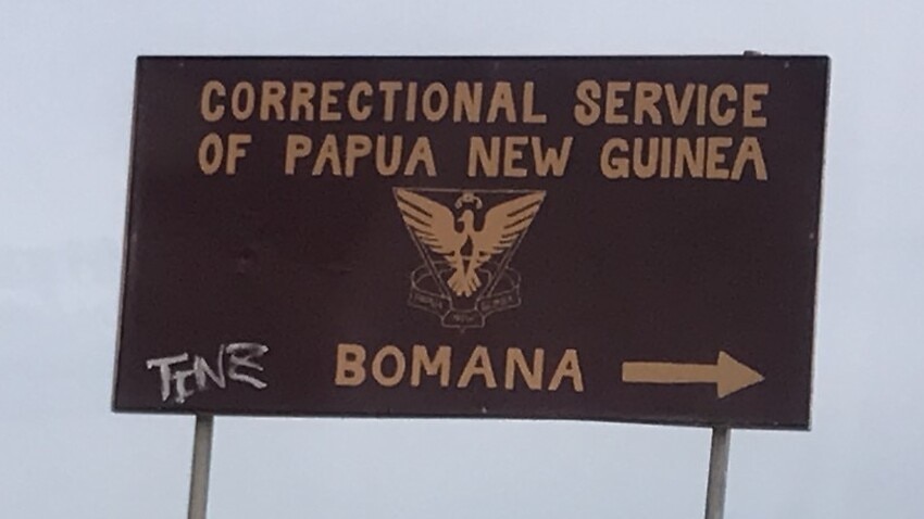 A sign to Bomana Correctional Service, located nearby the immigration centre.