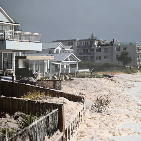 Sea foam brought by waves approach on beach front houses after heavy rain and storms at Collaroy in Sydney's Northern Beaches, Monday, 10 February, 2020.