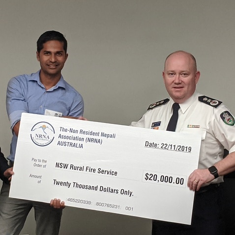 NSW Rural Fire Service Commissioner Shane Fitzsimmons accepting donation for members of Australia's Nepali community.