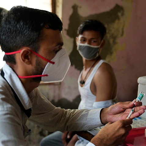 A health worker prepares to administer the vaccine for COVID-19 in New Delhi, India.