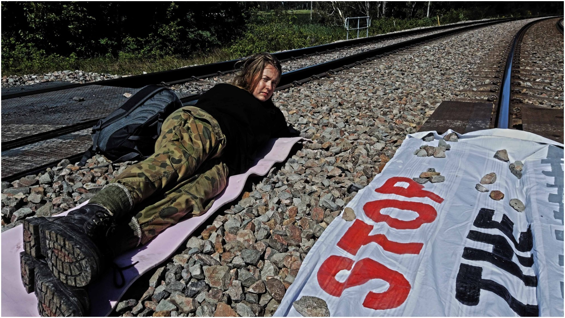 Young activists blocking train tracks.