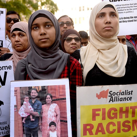 Demonstrators march through Sydney's CBD during a rally calling for refugee rights in Sydney.