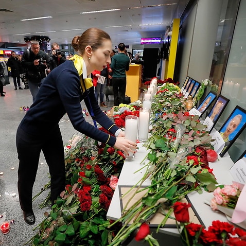 Friends and family of crew members of the crashed Ukraine International Airlines Flight lay tributes at the airport in Kiev