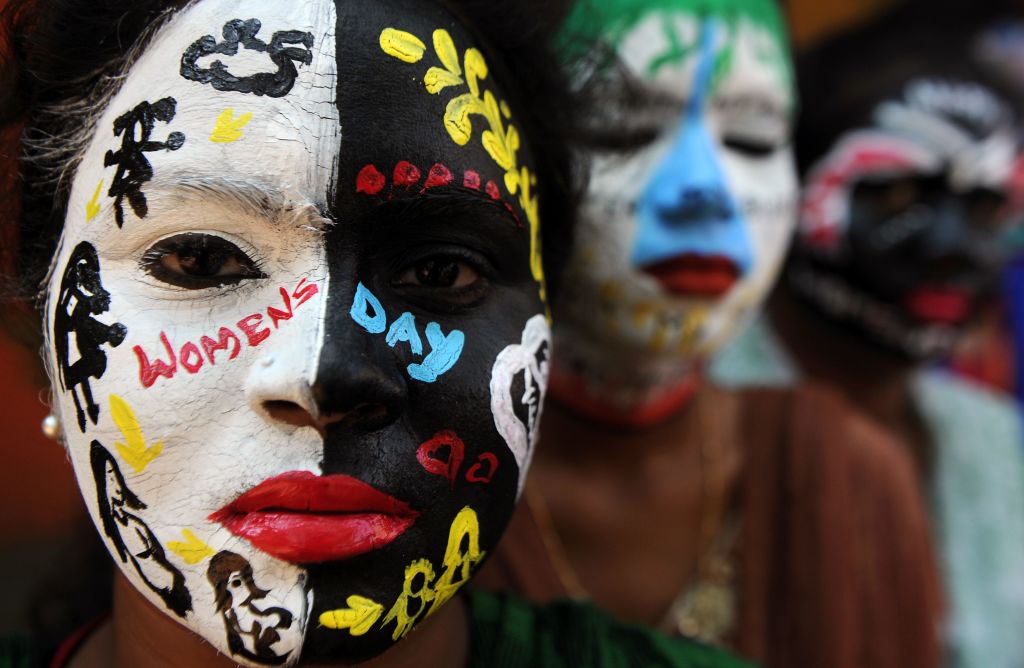 TOPSHOT - Indian students pose with their faces painted at a college in Chennai on March 7, 2017,  ahead of International Women's Day. / AFP PHOTO / ARUN SANKAR        (Photo credit should read ARUN SANKAR/AFP/Getty Images)