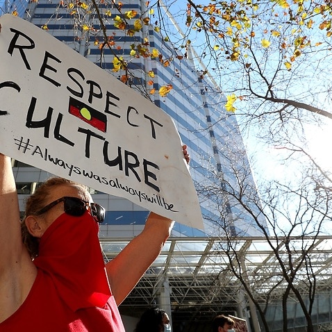 Protesters are seen during a rally outside the Rio Tinto office in Perth (AAP)
