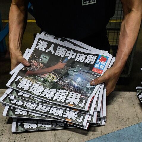 An Apple Daily employee works in the printing room after the last edition of the newspaper is printed in Hong Kong early on 24 June, 2021.