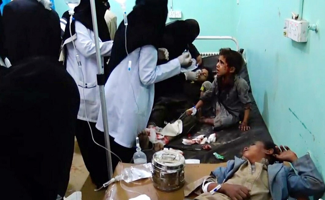 Wounded Yemeni children lying on beds receiving treatment at a hospital after being injured in an alleged Saudi-led airstrike