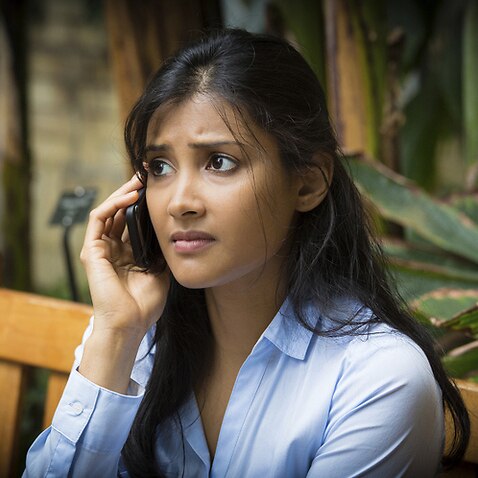 worried young woman talking on phone