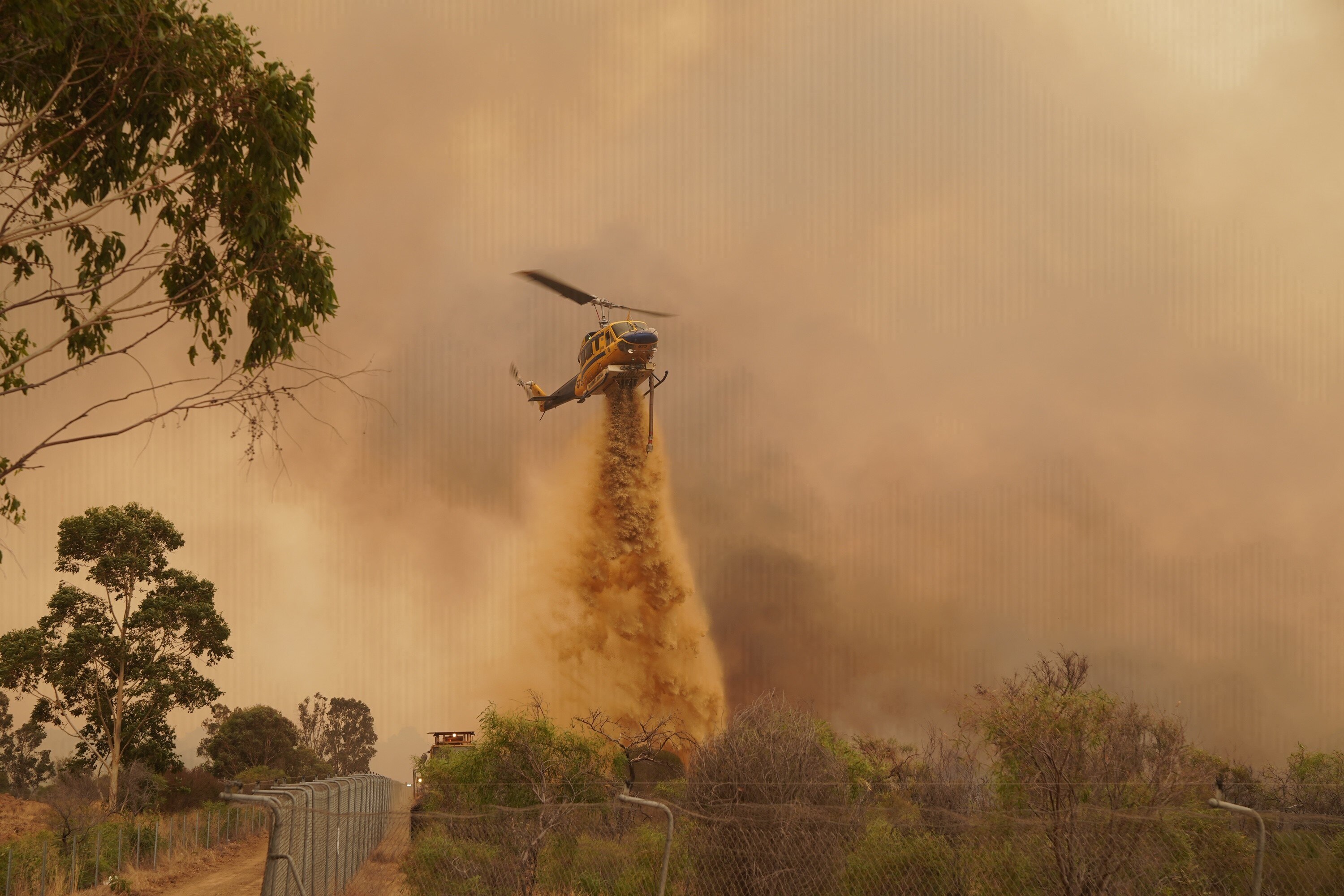 A supplied image of DFES fire fighters battling the Wooroloo Bushfire, north-west of Perth, Tuesday, 2 February, 2021.