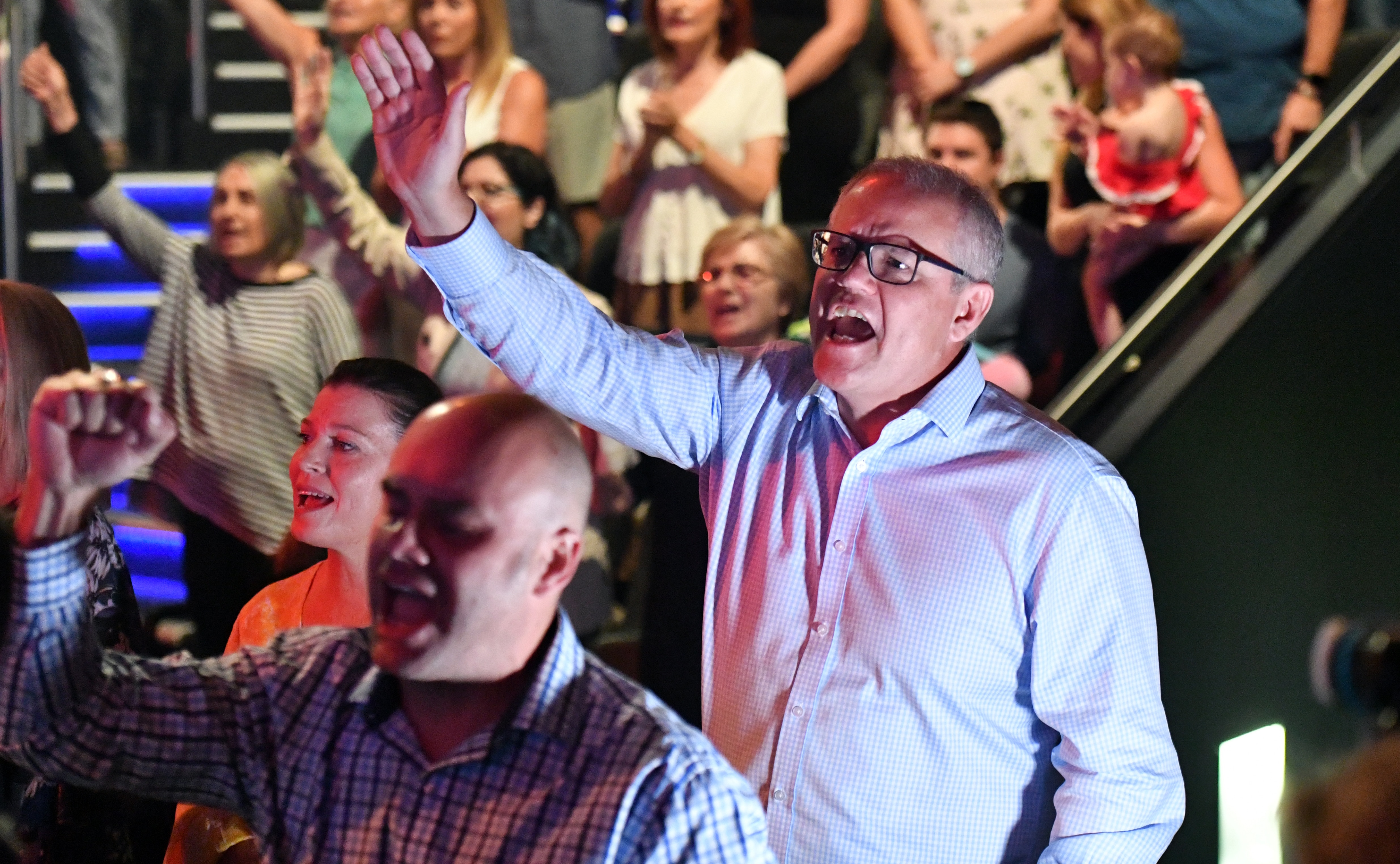 Prime Minister Scott Morrison and wife Jenny sing during an Easter Sunday service at his Horizon Church at Sutherland in Sydney.