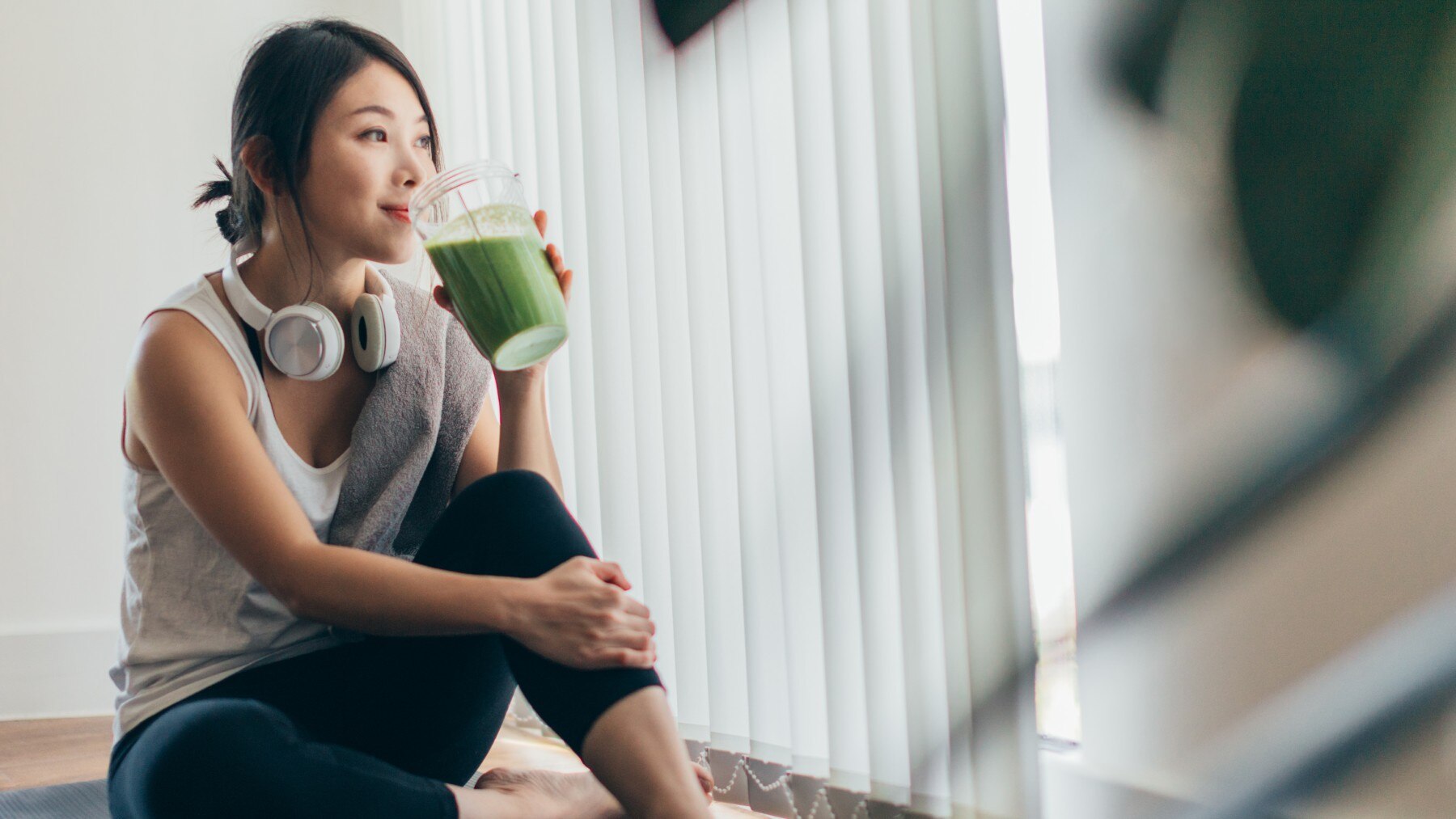 A woman drinking green smoothie