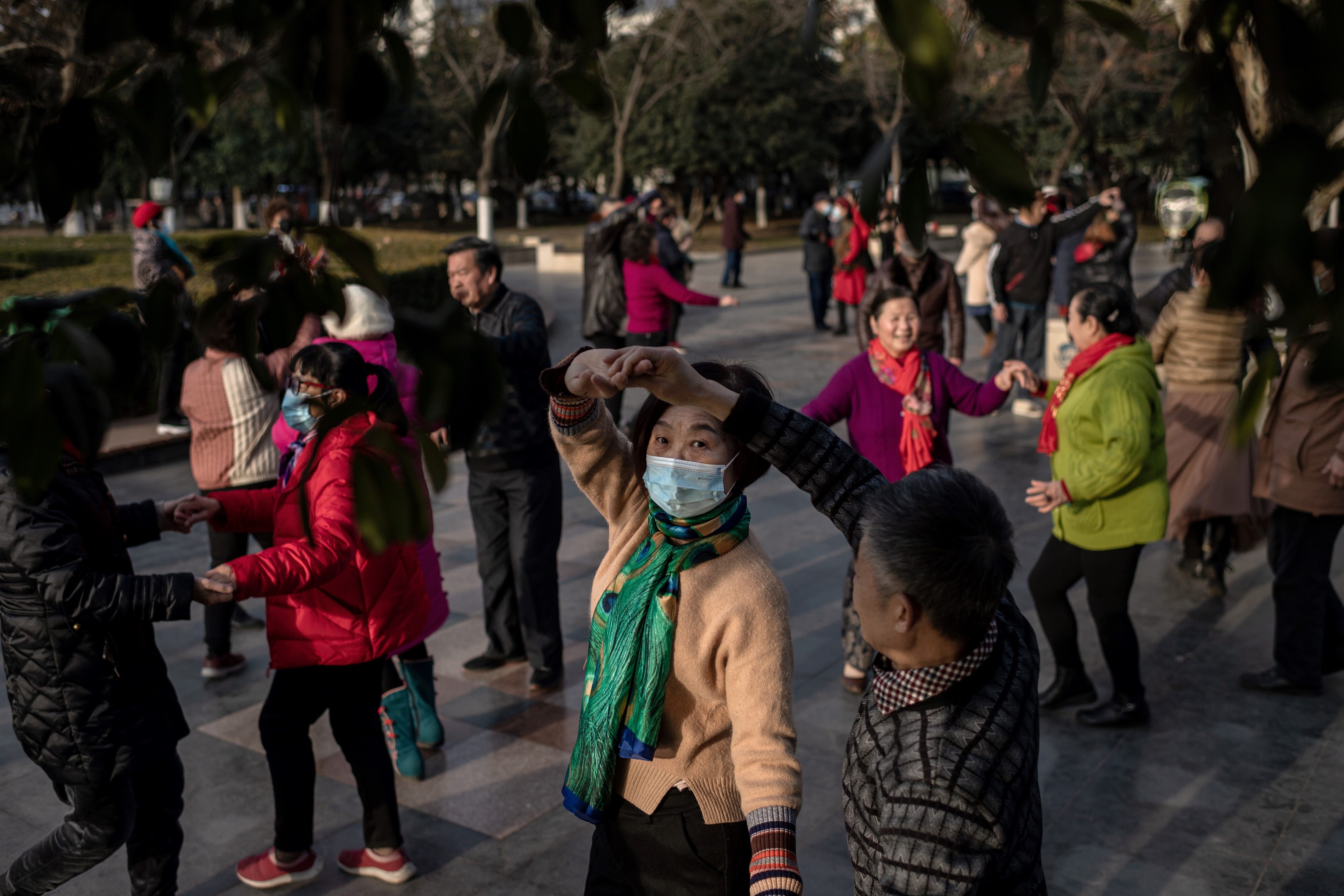 Elderly people dance in a public area along the Yangtze River in Wuhan on 11 January, 2021.