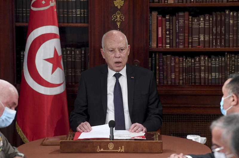 Tunisia's President Kais Saied, center, leads a security meeting with members of the army and police forces in Tunis, Tunisia, Sunday, July 25, 2021.