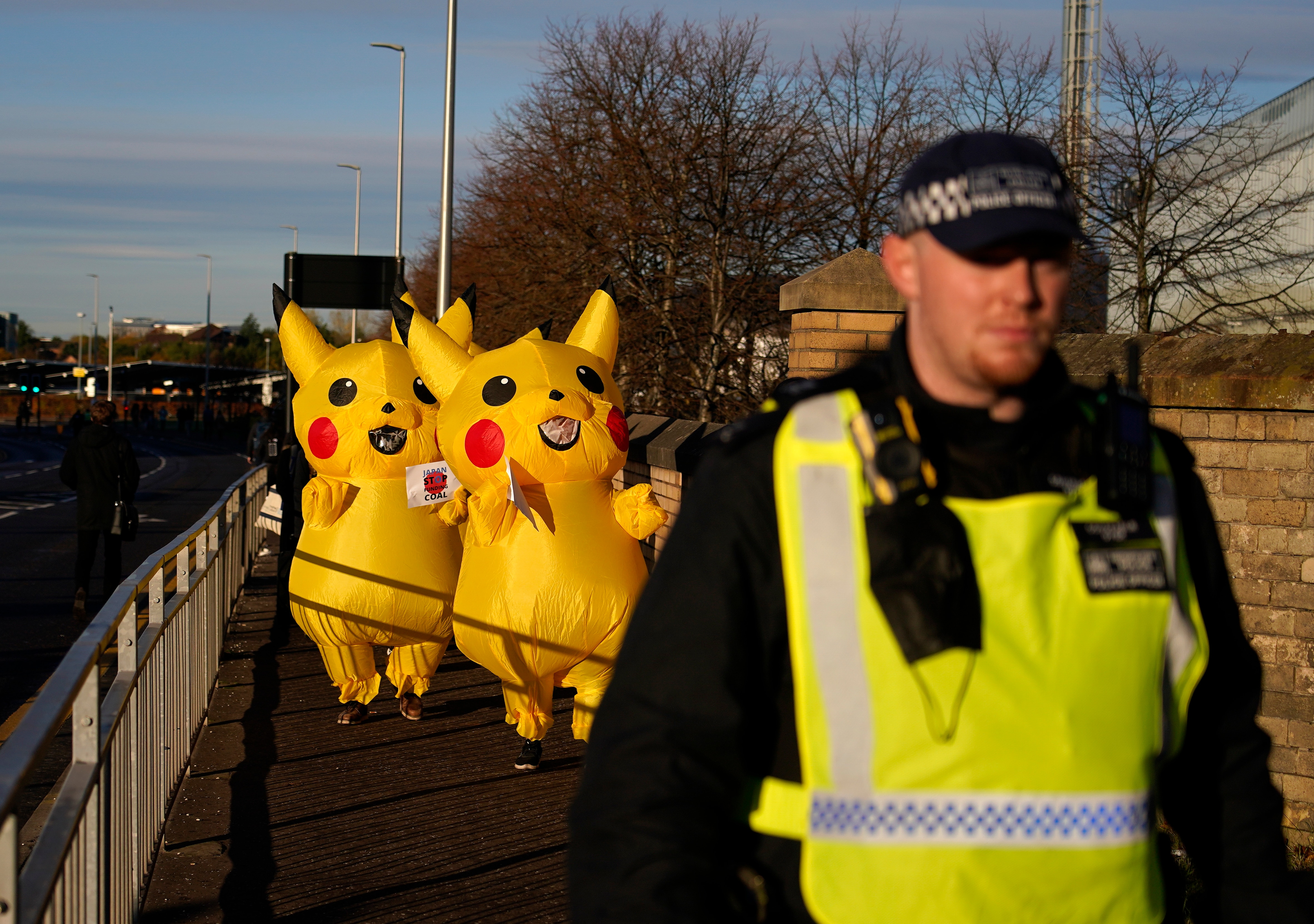 Activists dressed as the Pokemon character Pikachu protesting against Japan's support of the coal industry at the COP26 summit in Glasgow.