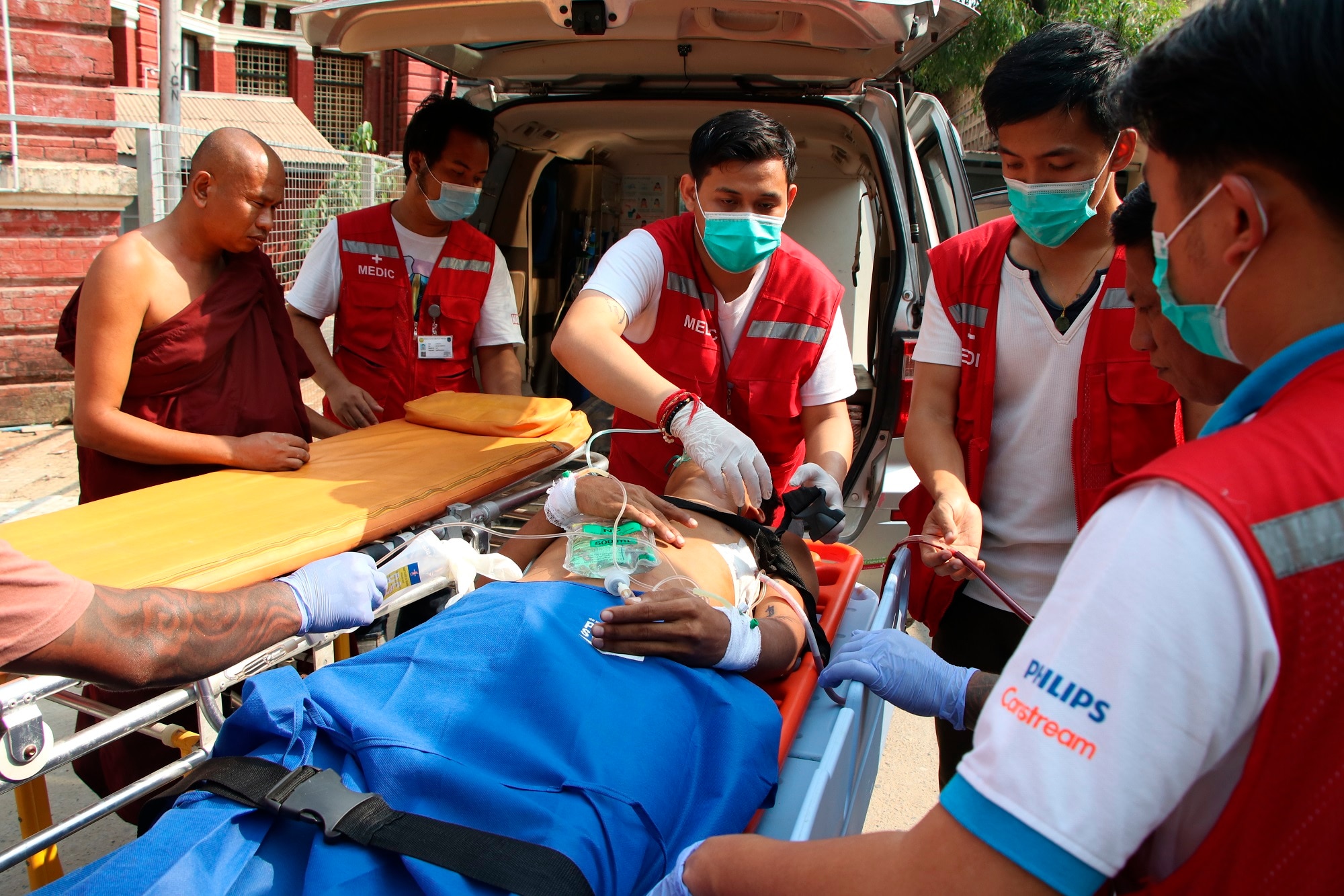 An injured anti-coup protester is brought in for medical treatment at a hospital in Latha township, Yangon, Myanmar.