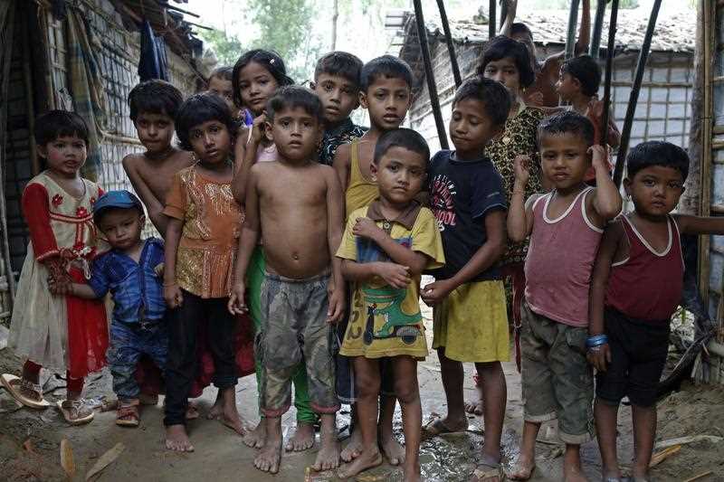 A group of Rohingya refugee children stand at a makeshift camp in Cox's Bazar, Bangladesh.