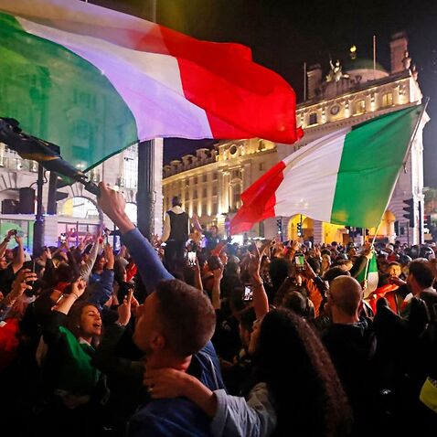 Italy supporters celebrate their team's victory at Piccadilly Circus after the EURO 2020 final football match between England and Italy, in London. 