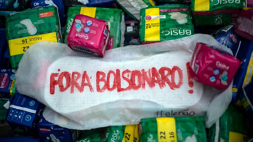 A menstrual pad that reads in Portuguese "Bolsonaro Out" sits over donated womens hygiene products during a protest October 13, 2021.
