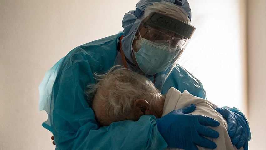 Doctor seen comforting distraught elderly coronavirus patient in viral  photo speaks out