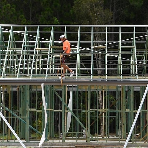 A tradesperson is seen constructing a new home.