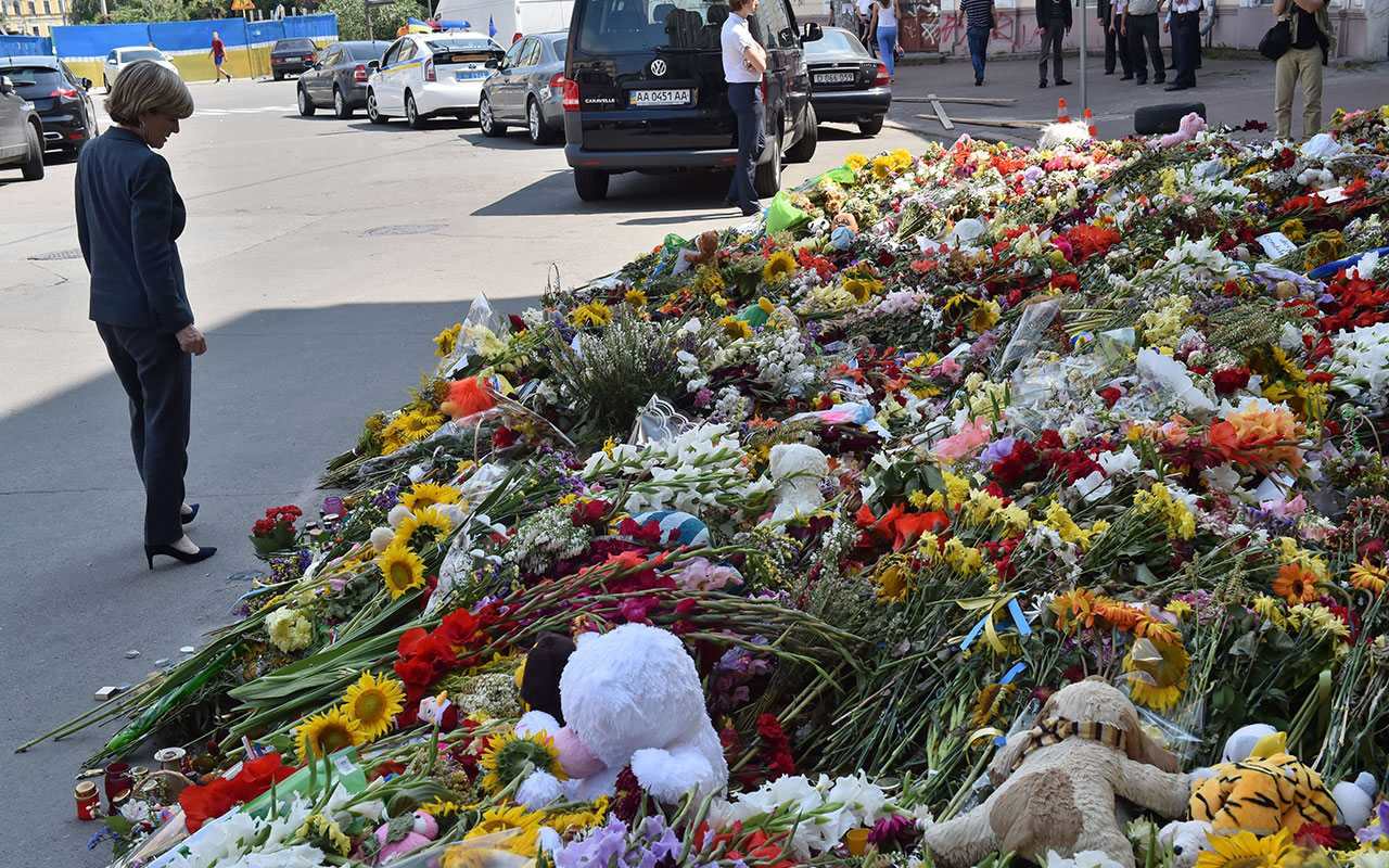   Julie Bishop walks past flowers in memory of the victims of the MH17 flight in front of the Dutch Embbady in Kiev on July 2, 2014. 